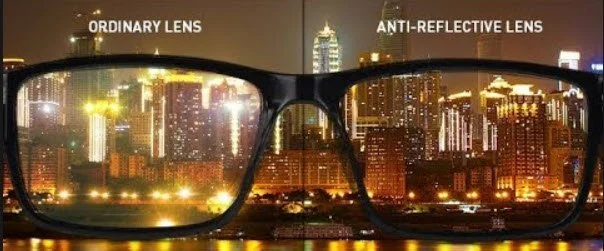 glasses with city scene in the background showing ordinary lens view and anti-reflective lens view