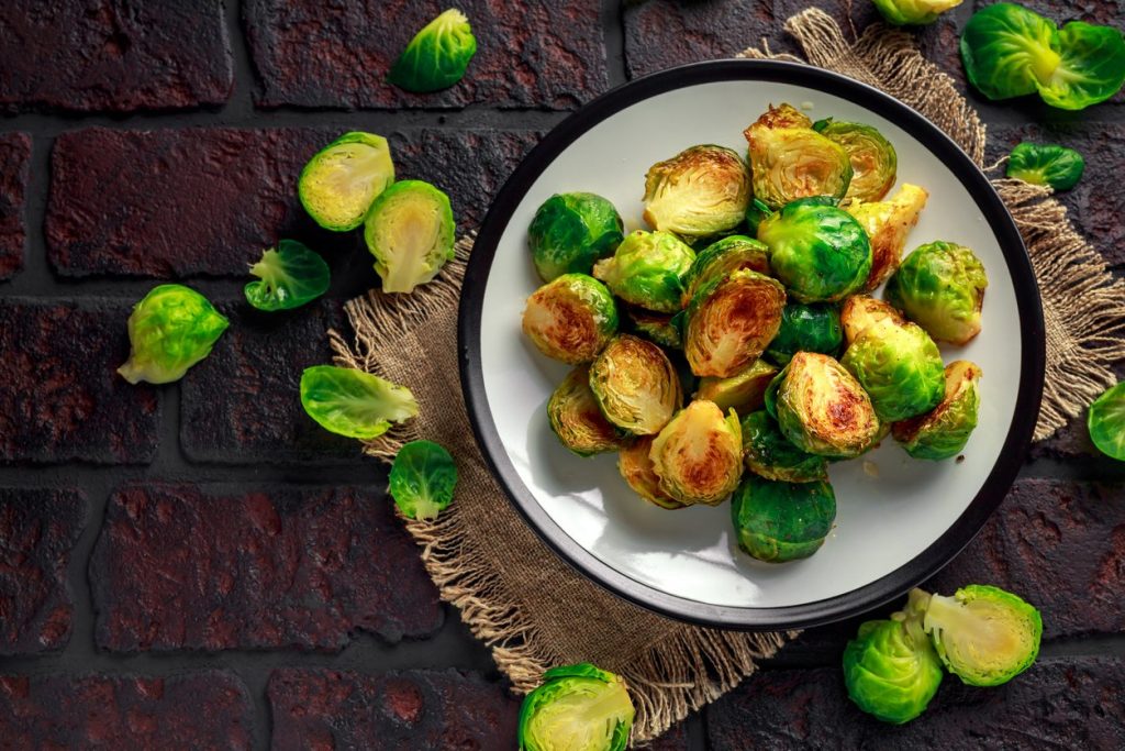 Homemade Roasted Brussel Sprouts with Salt, Pepper on a old stone rustic table