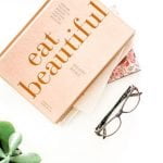 glasses sitting on white table with a box that reads, eat beautiful