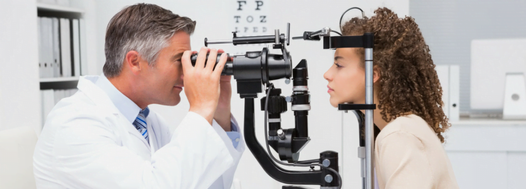 diabetic eye exam, photo shows diabetic eye doctor using a slit lamp on a patient, which can detect diabetes in the eye its early stages. 