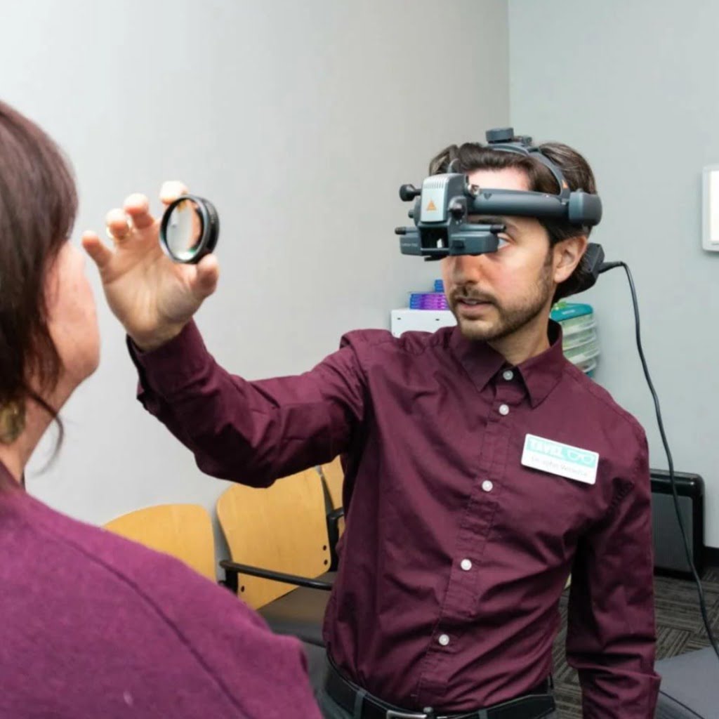 optometrist using special testing equipment during an eye exam